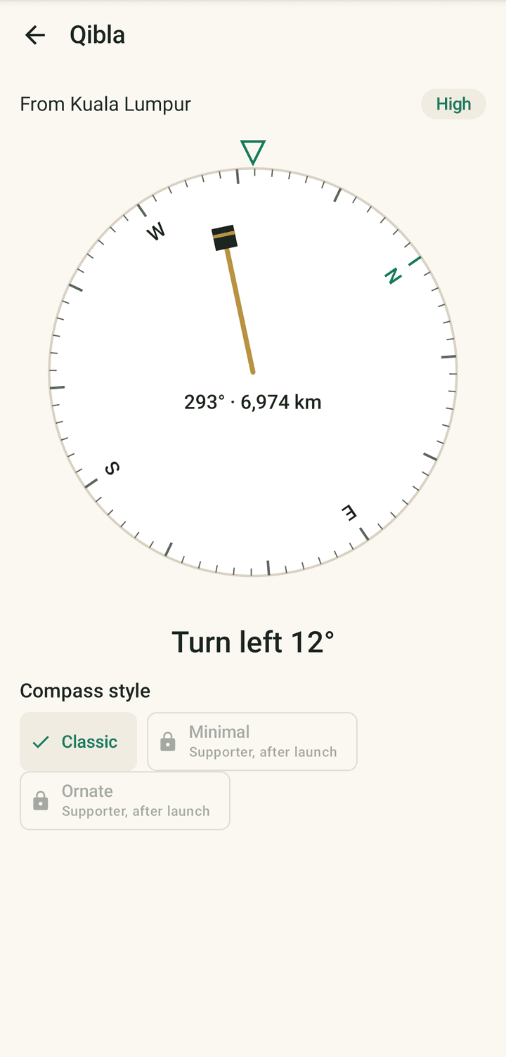 The Qibla compass from Kuala Lumpur: bearing 293 degrees, 6,974 km, high accuracy, and the instruction "Turn left 12°".